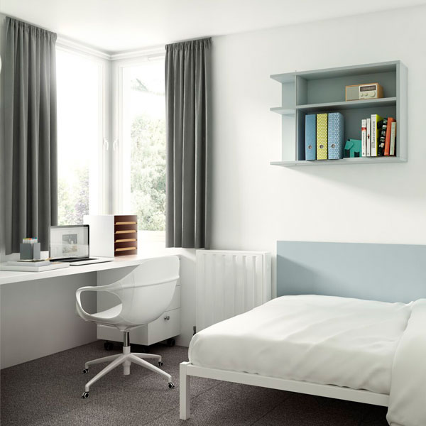 Halls of residence bedroom with bed and desk