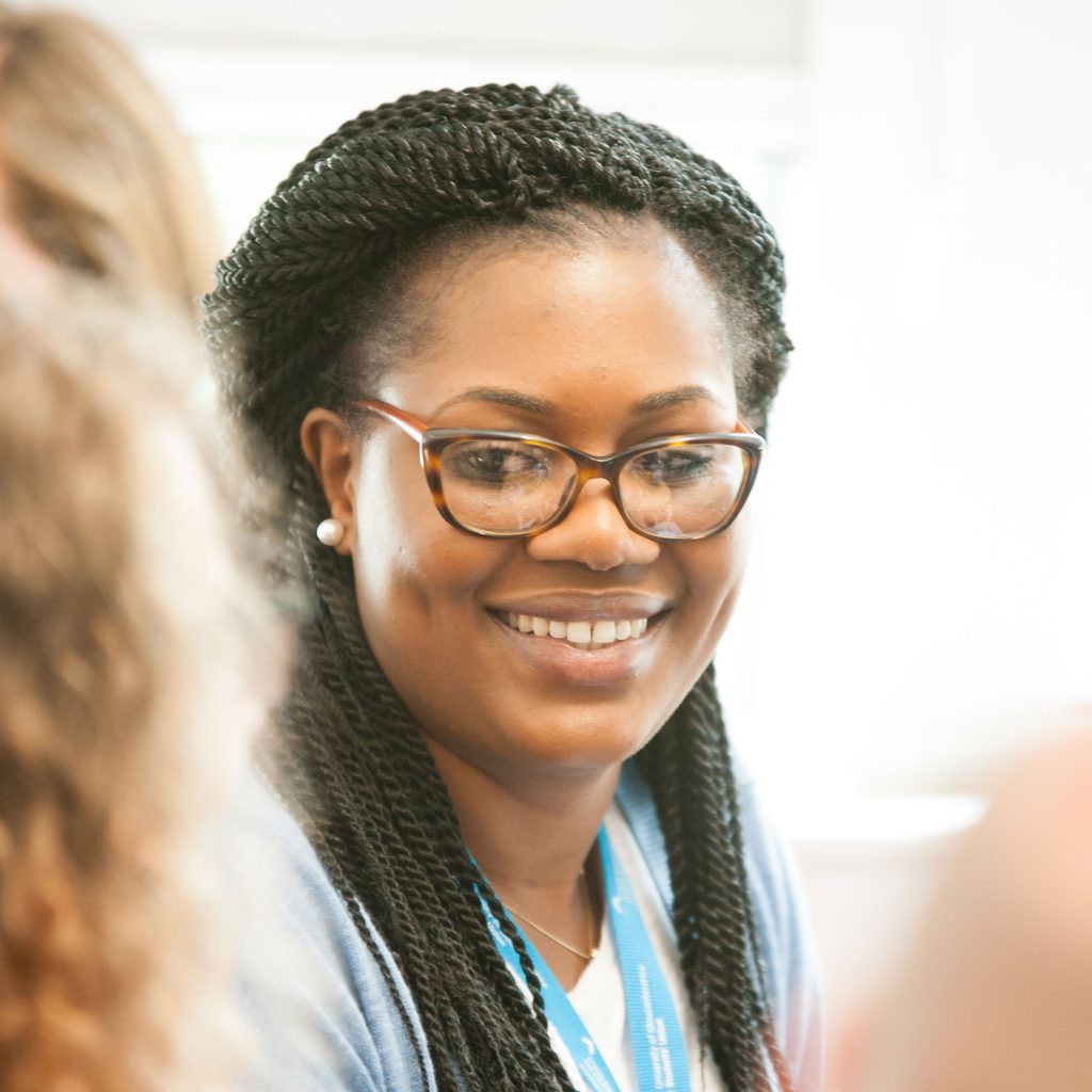 Student with glasses smiling