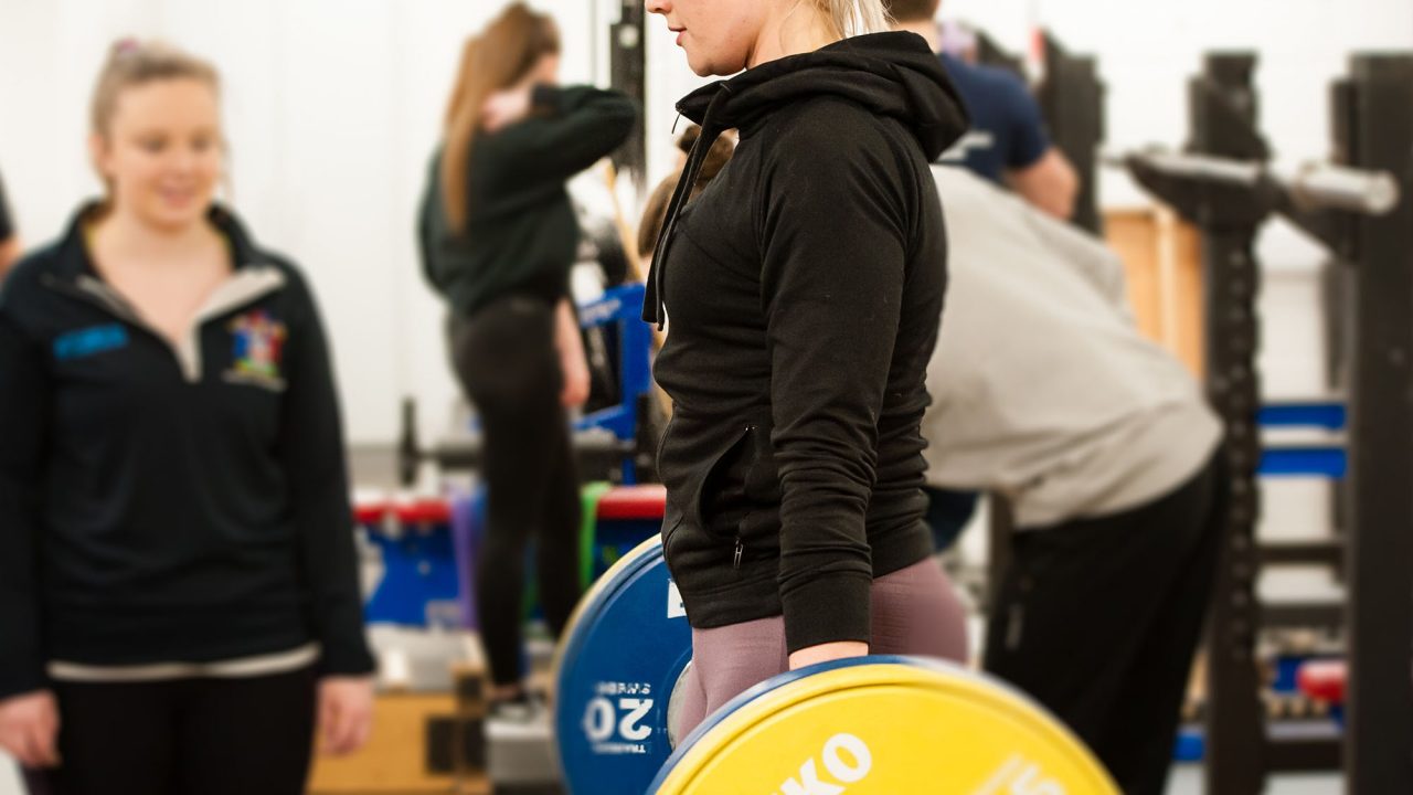 Student on the Strength, Conditioning and Rehabilitation course lifting weights at Oxstalls campus