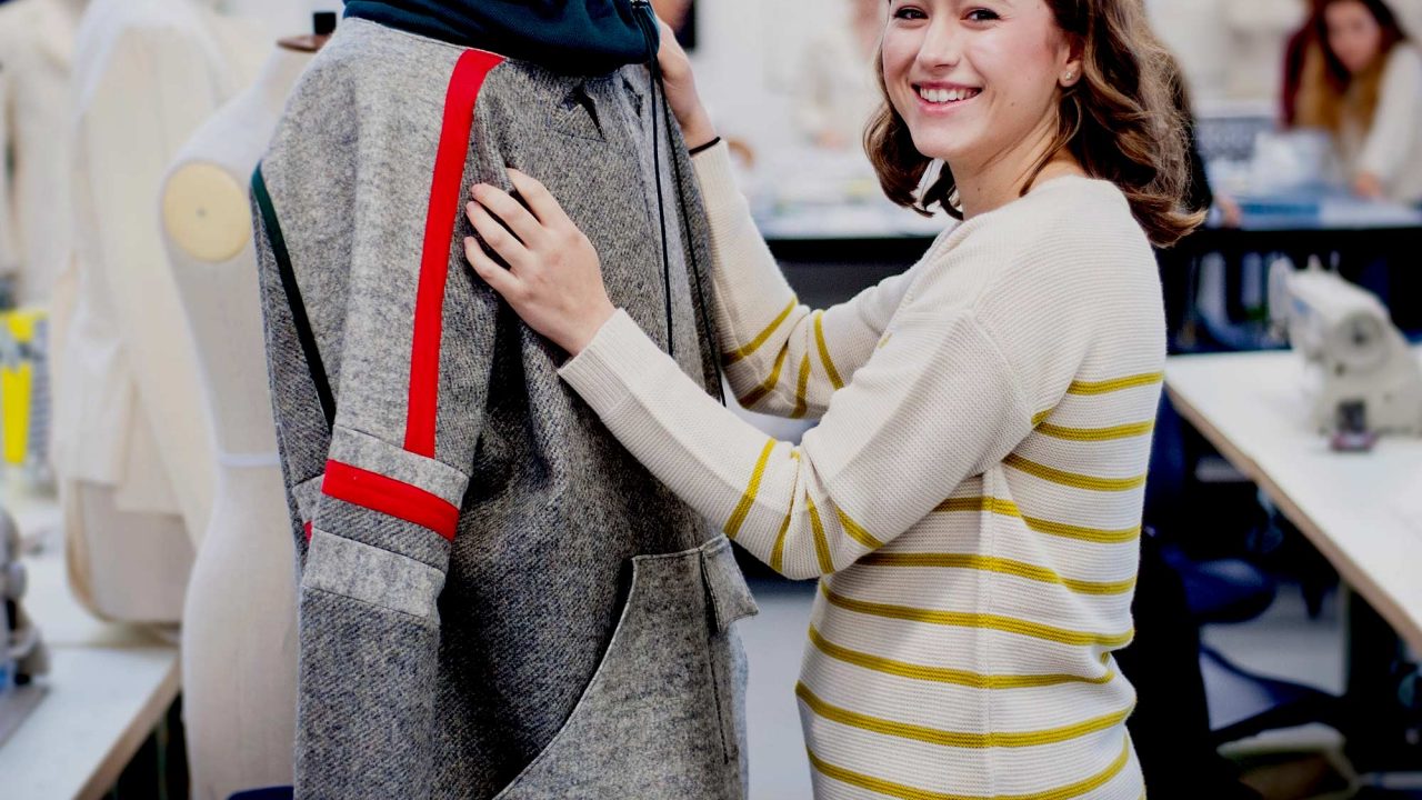 Fashion student dressing a mannequin