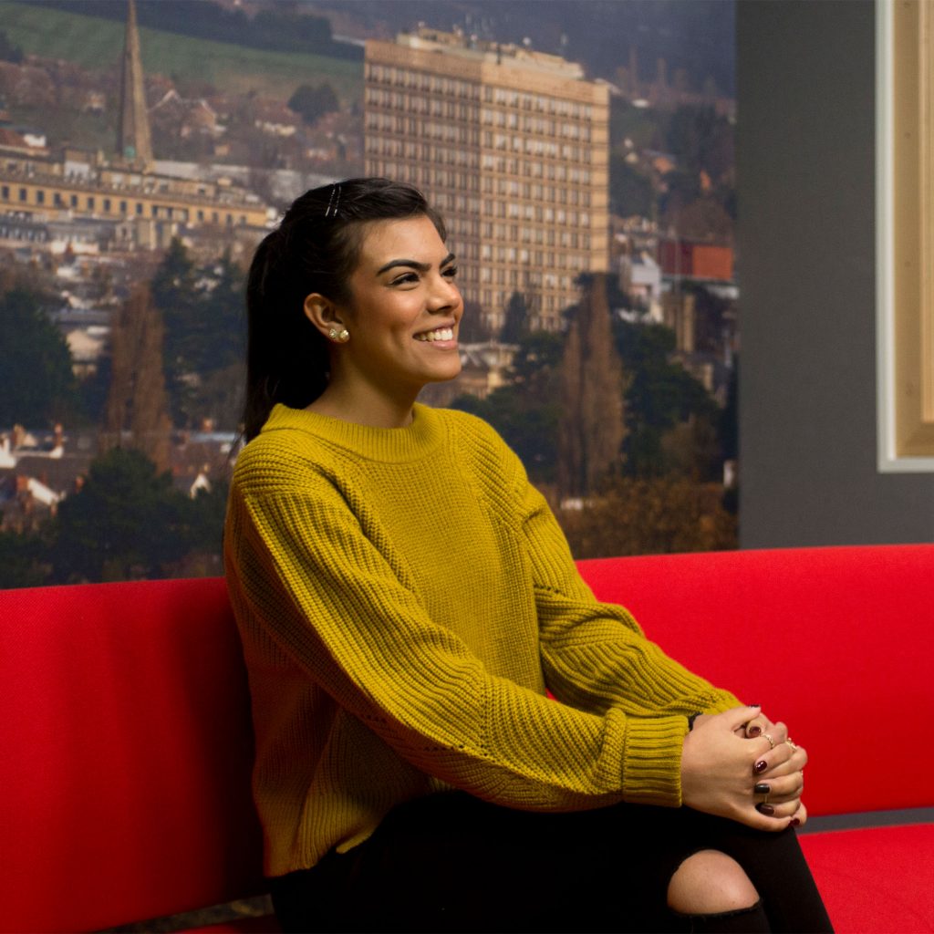 Student (Jade Padam) on Journalism course sitting on the sofa in the media studio at Park campus