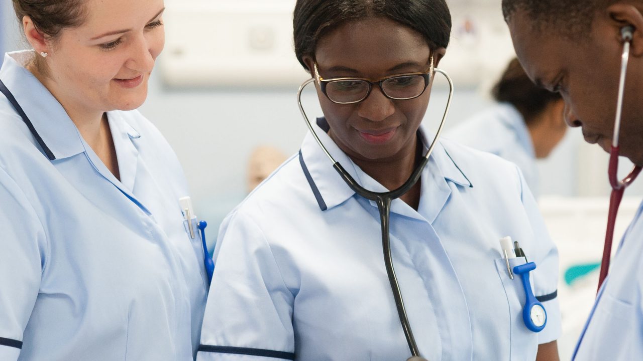 Students on Health and Social Care Advanced Professional Practice course looking at the gauge of a blood pressure monitor