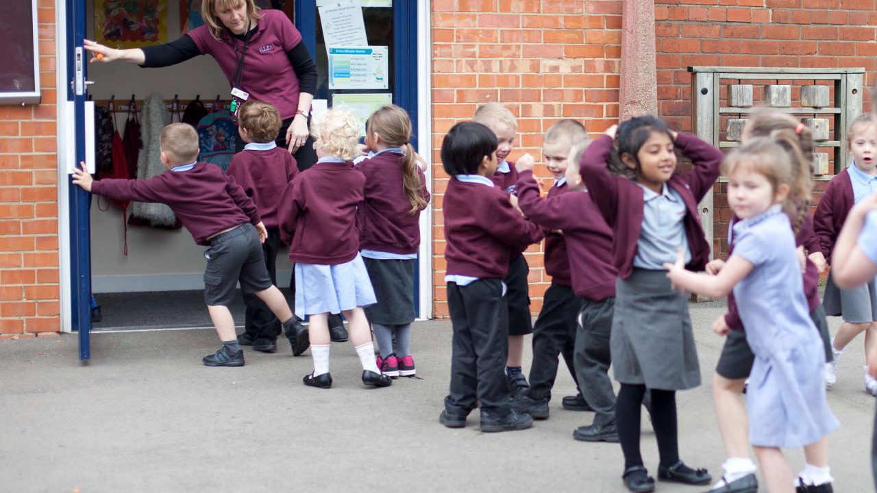 eyw – education and humanities – Early Years (Postgraduate Certificate) A teacher holding the door open for infant school pupils to go into the classroom