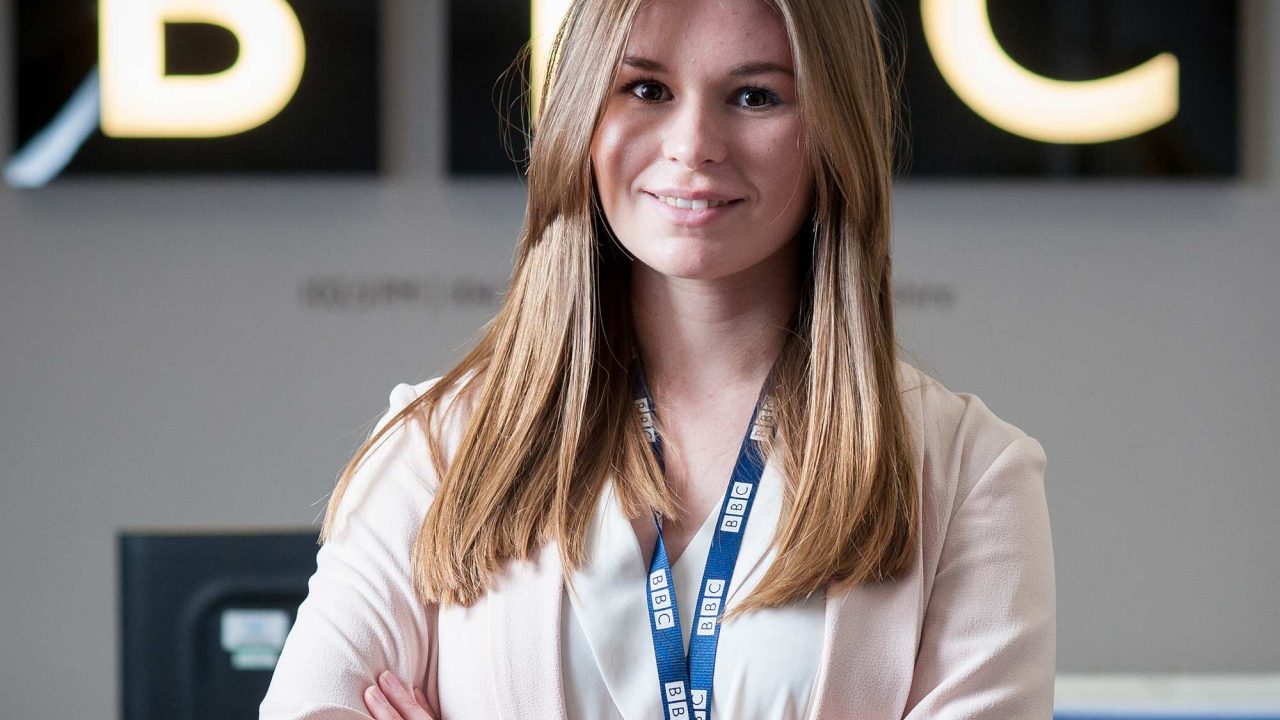 Abigail Mobbs Graduate smiling infront of BBC sign