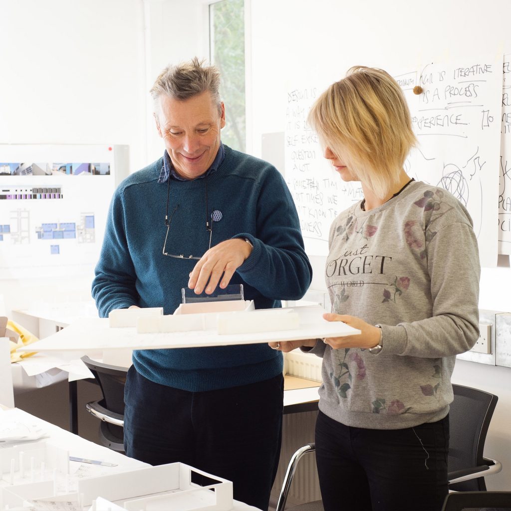 Student and lecturer looking at a model building