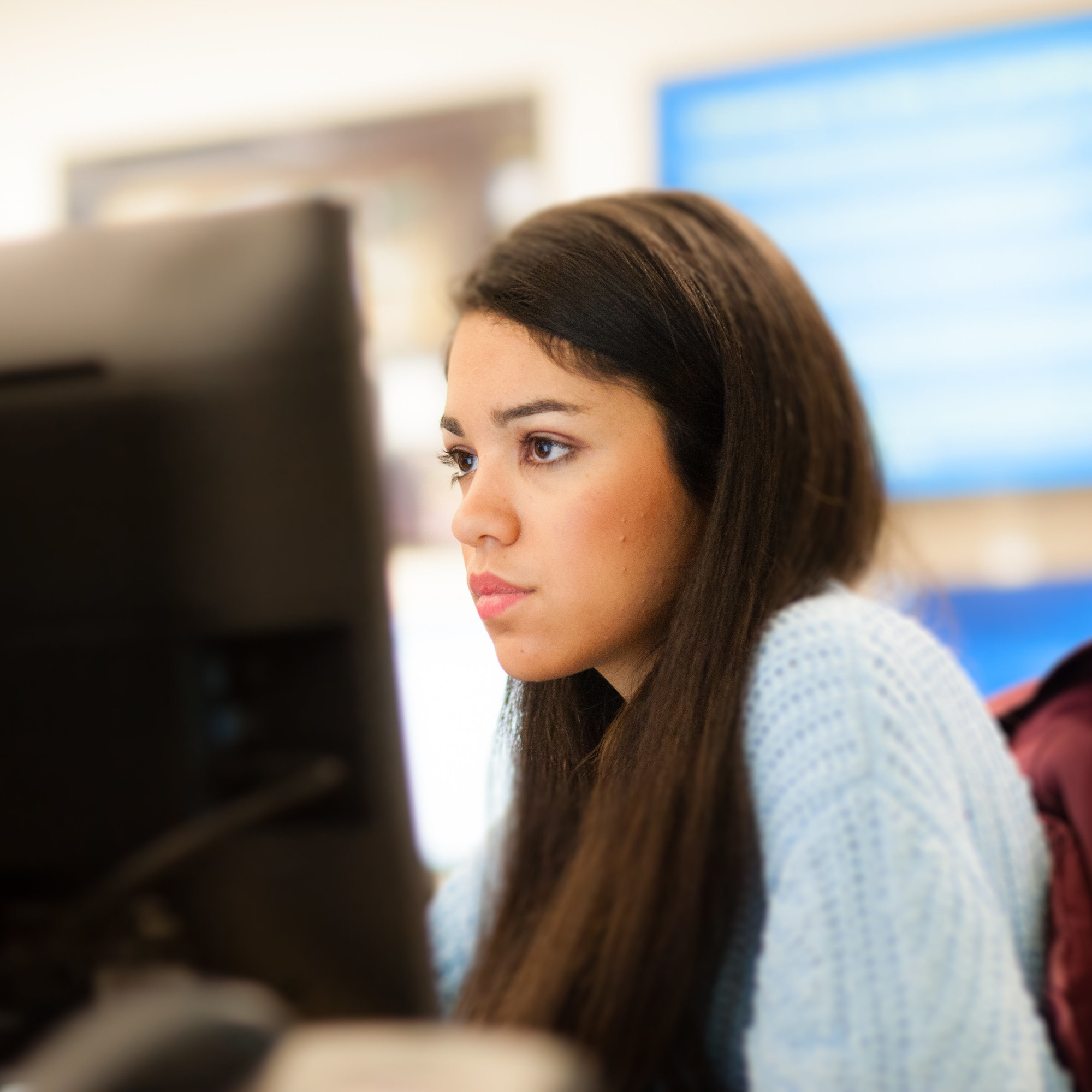 woman looking at a computer screen