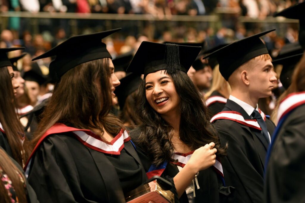 University of Gloucestershire graduates wearing gowns and mortarboards at their graduation ceremony