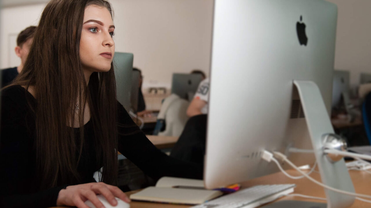 Student working on Apple iMac in classroom