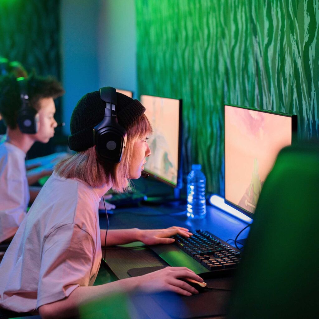 A woman wearing headphones using a computer