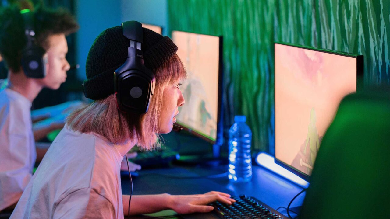 A woman wearing headphones using a computer
