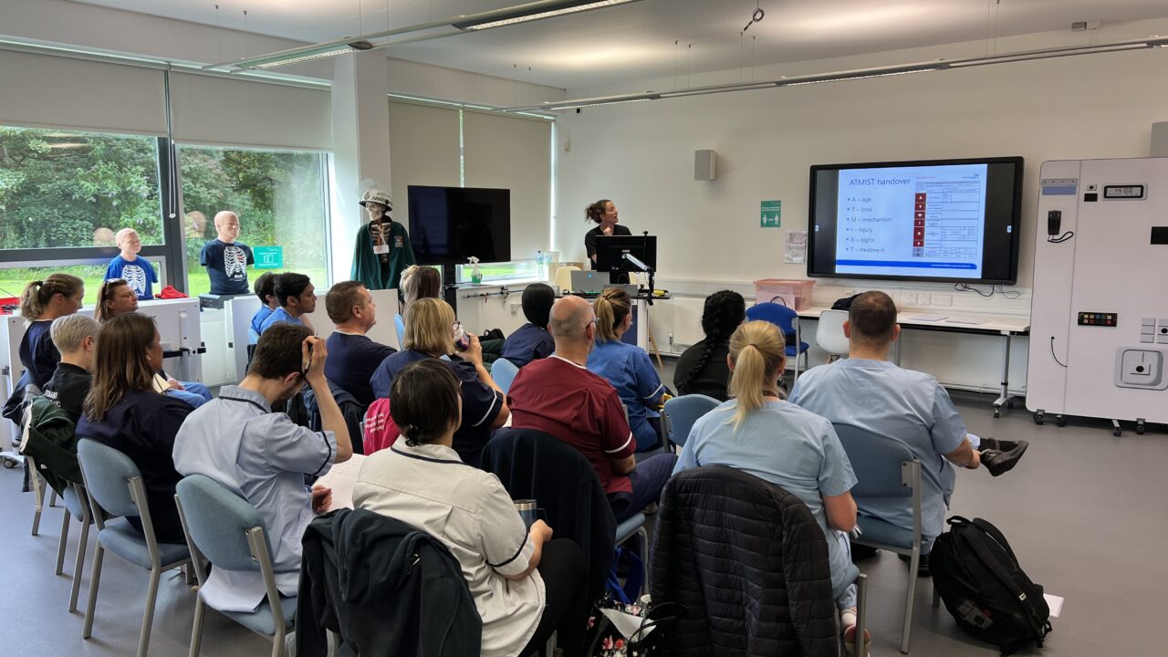 a group of people looking at a screen