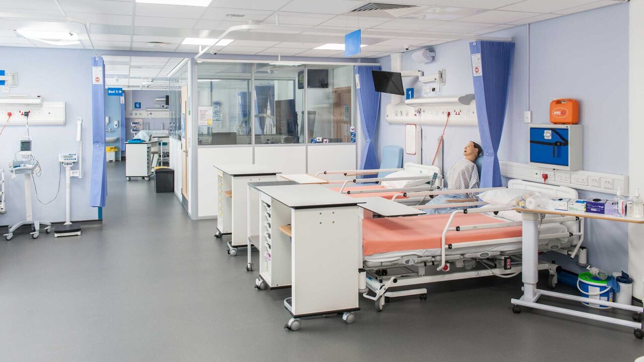A view of the mock hospital ward showing beds and healthcare equipment.