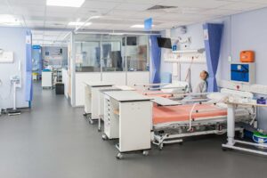 A view of the mock hospital ward showing beds and healthcare equipment.