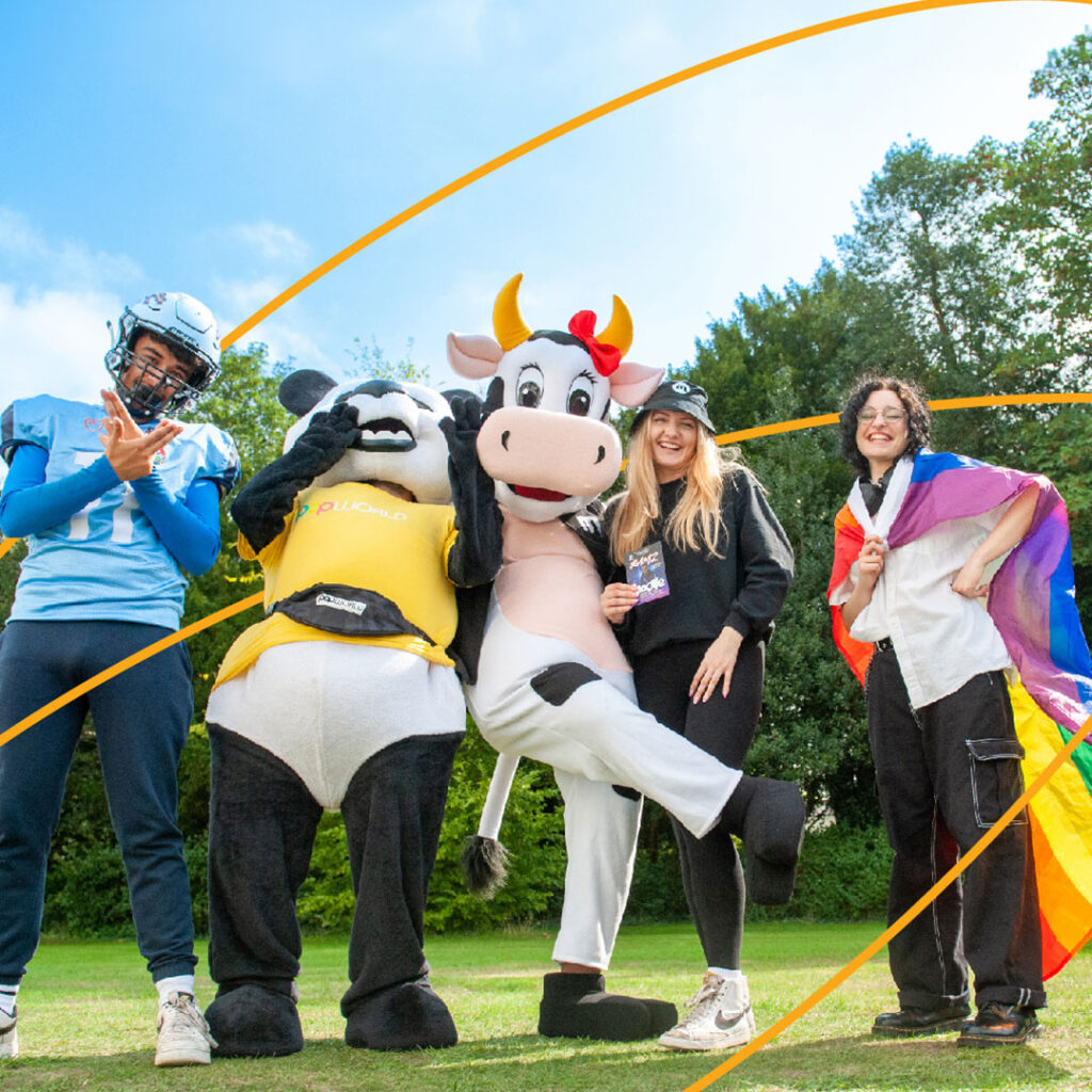 Students from various clubs and society posing with mascots at Freshers Fayre.