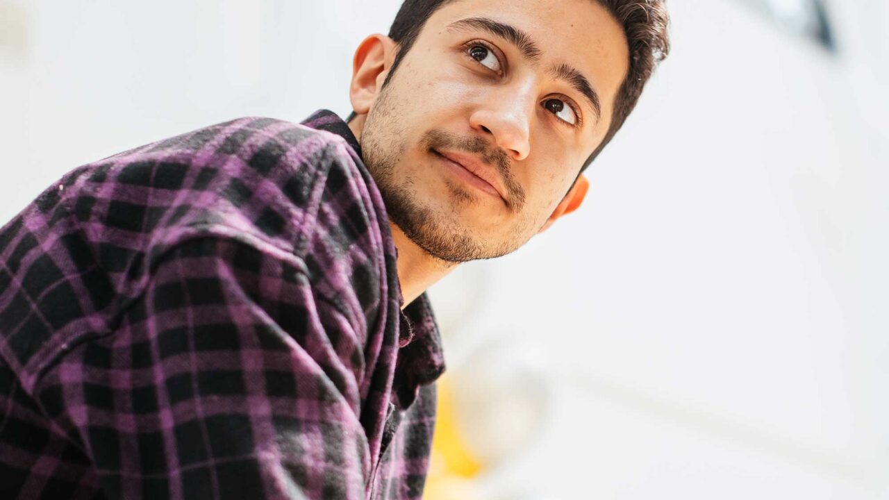 A male student looking into the distance