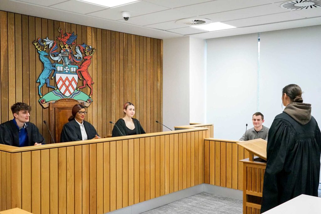 Students in robes in UOG's moot court.