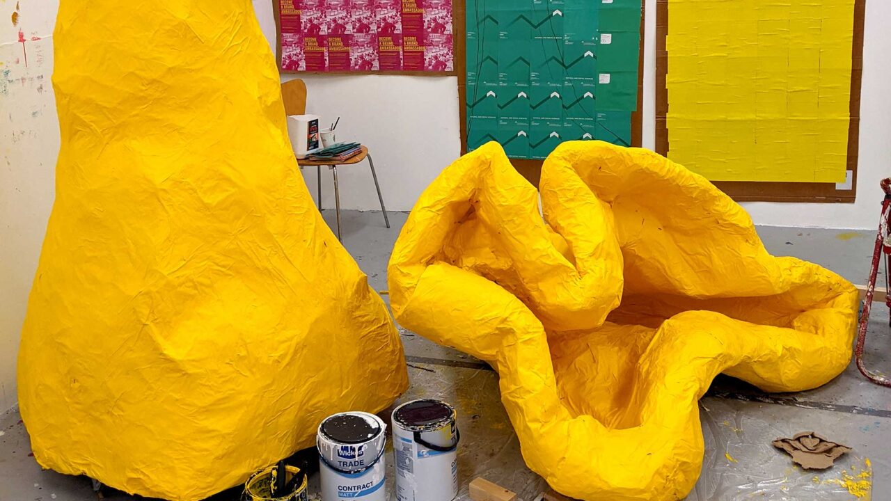studio-teaching Large yellow pieces of artwork.