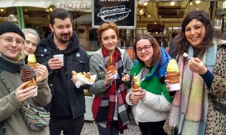 trips-and-residencies A group of six students eating ice creams and hotdogs.