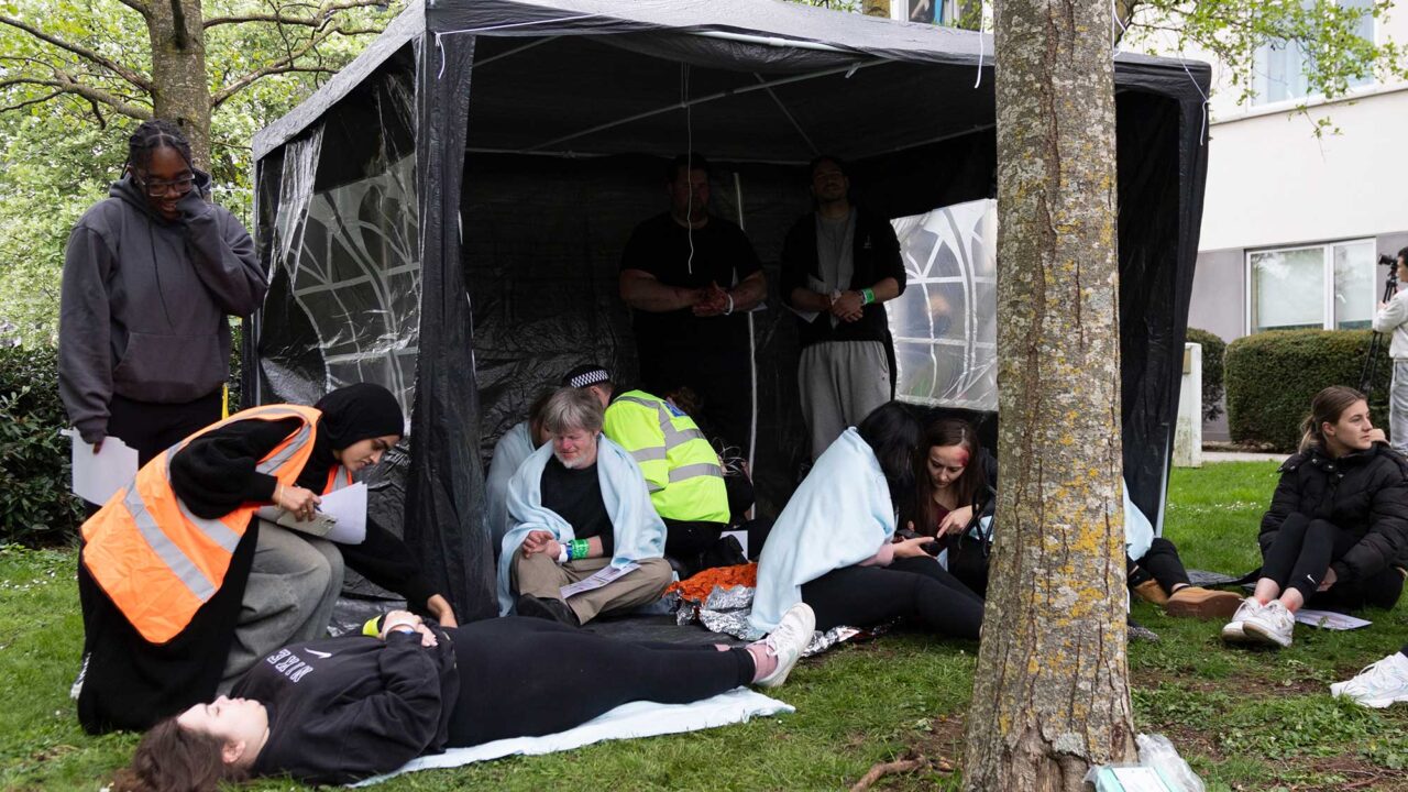Students deal with 'casualties' in a tent during the University's simulated major emergency.