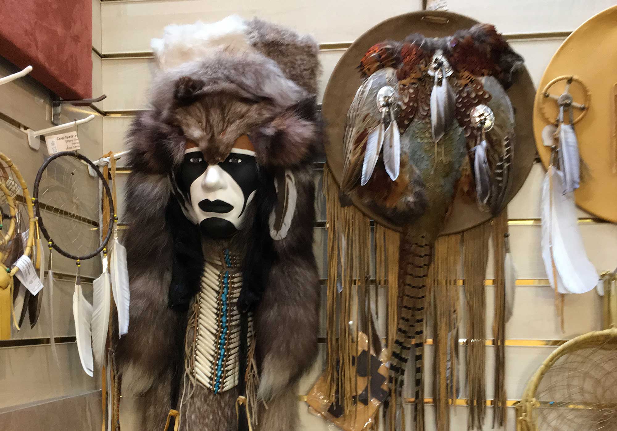 Traditional spiritual headwear hanging on pegs in a shop in Glastonbury.