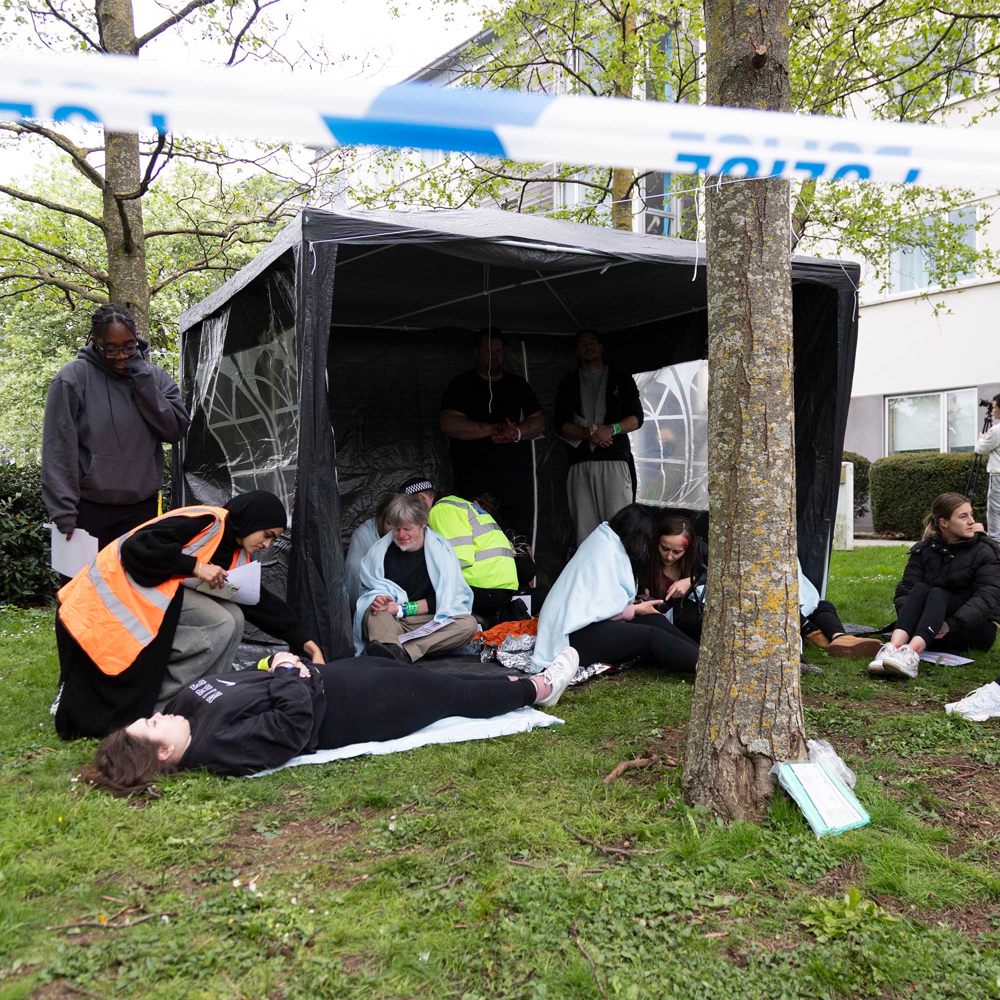 Students deal with 'casualties' in a tent during the University's simulated major emergency.