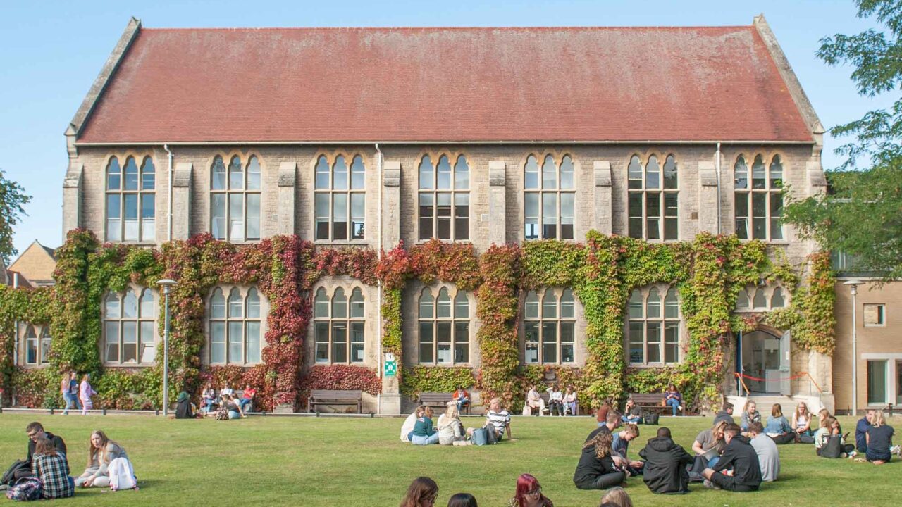 Groups of students sitting on the lawn outside FCH.