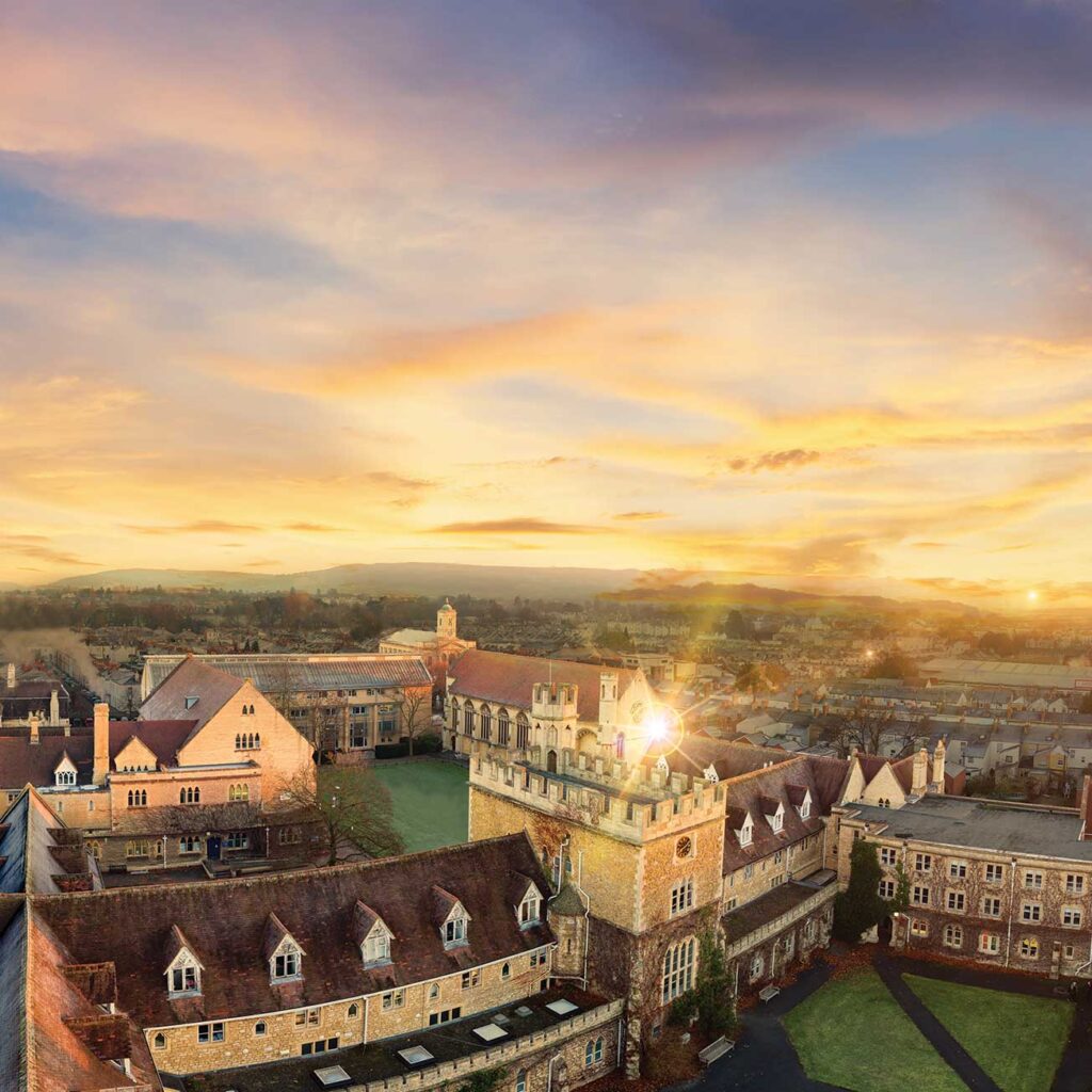 Sunset over Francis Close Hall with a view of the hills in the background.