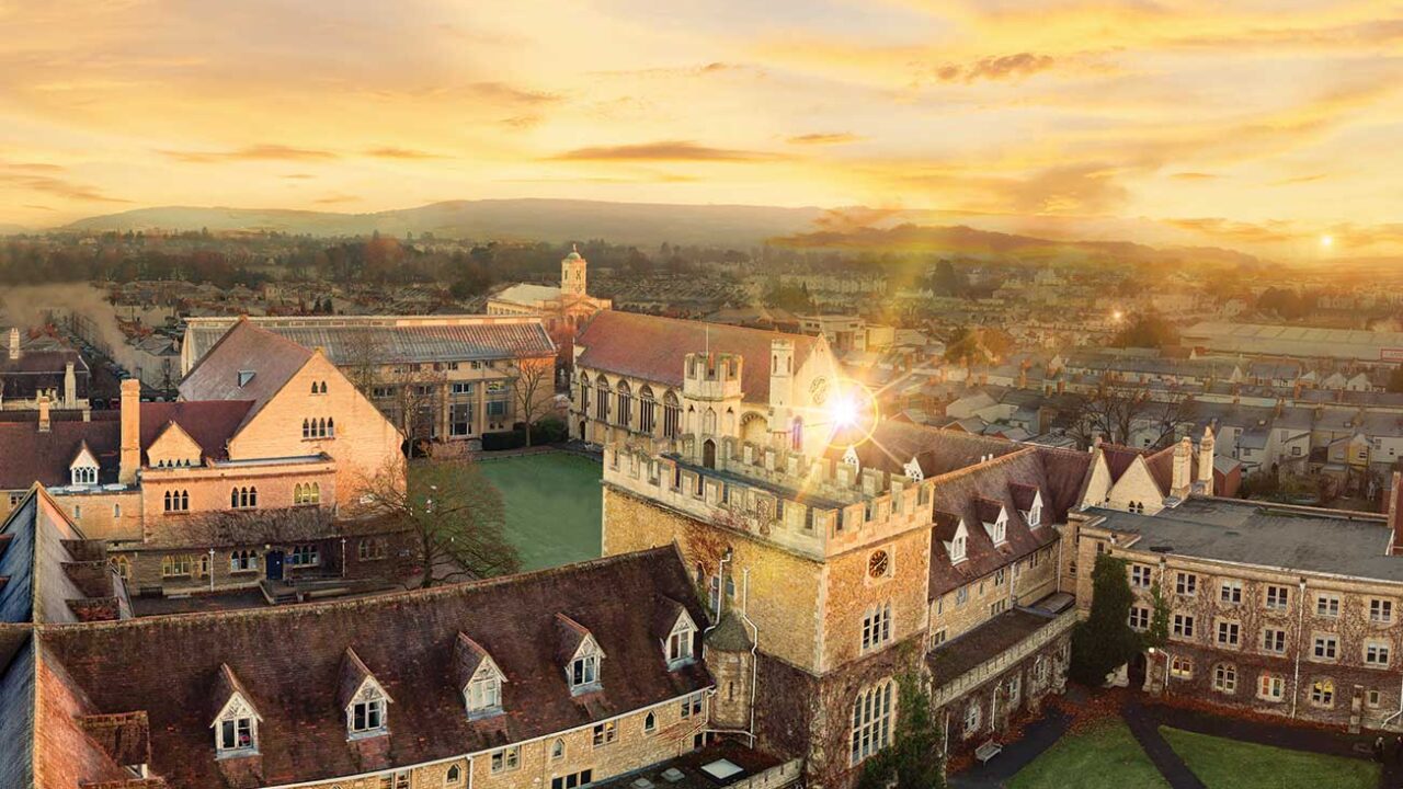 Sunset over Francis Close Hall with a view of the hills in the background.