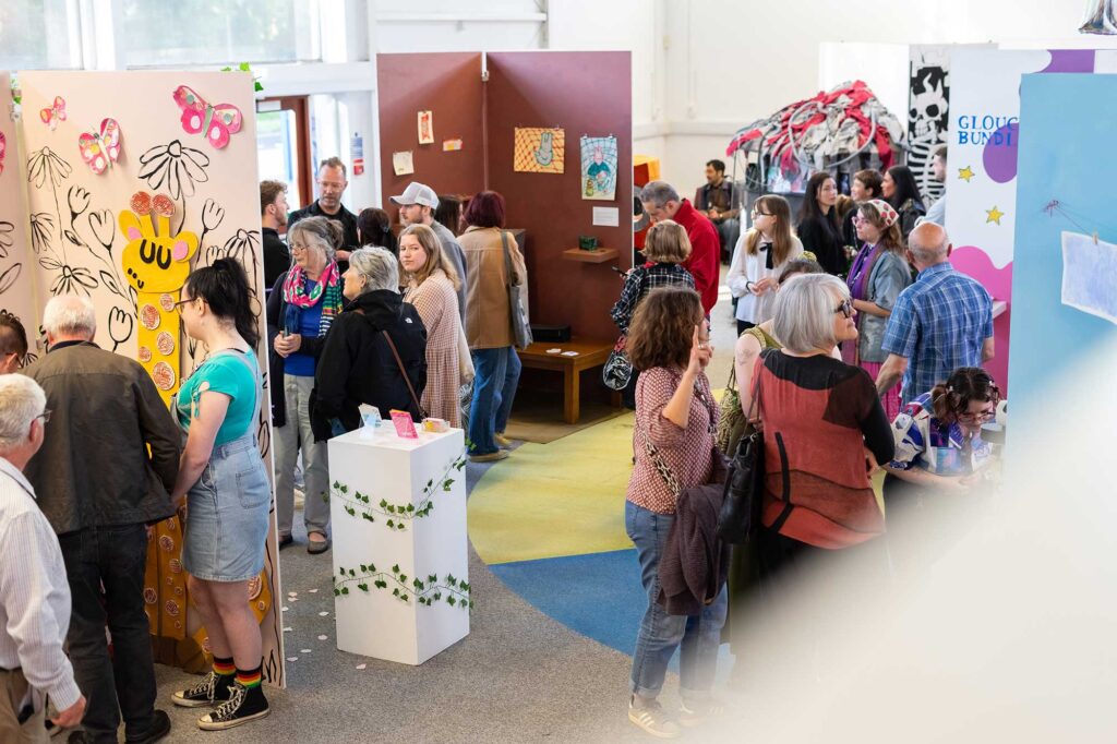 An exhibition space with stands displaying students' artwork.