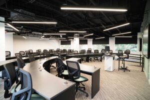 Computing suite at FuturePark showing desks in a semi-circle and two large flat screens at the front.