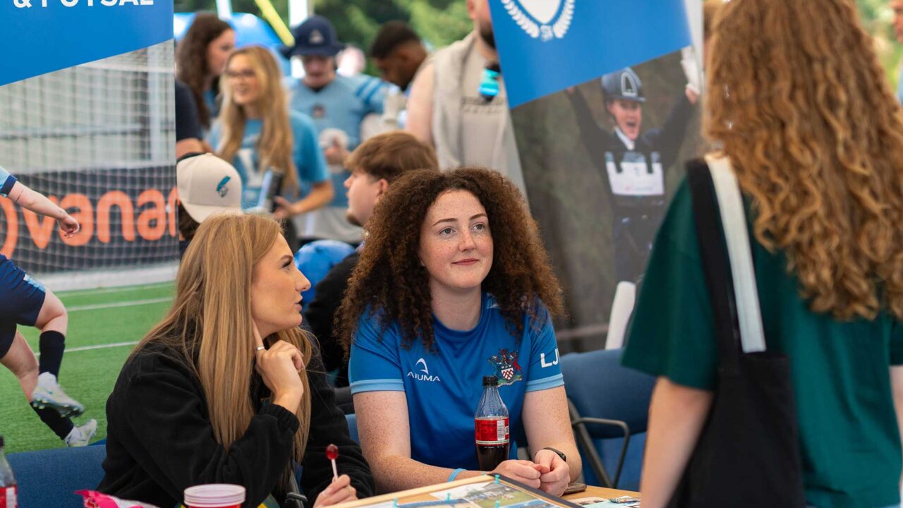 Students speak to sports society members at the Welcome Fayre.