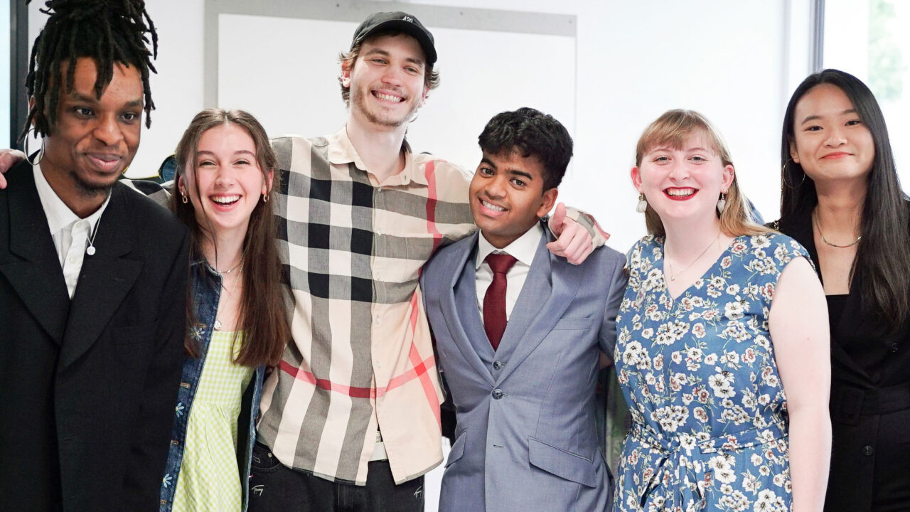 Students stood in a row smiling at camera at Park Campus