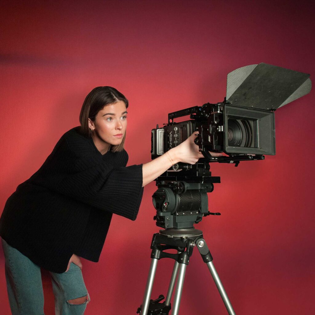 A Film and TV Production student uses a camera in a studio.