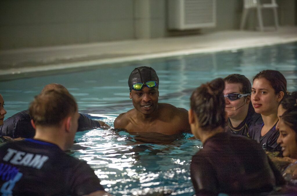 Swimmers assembled in a circle in a swimming pool