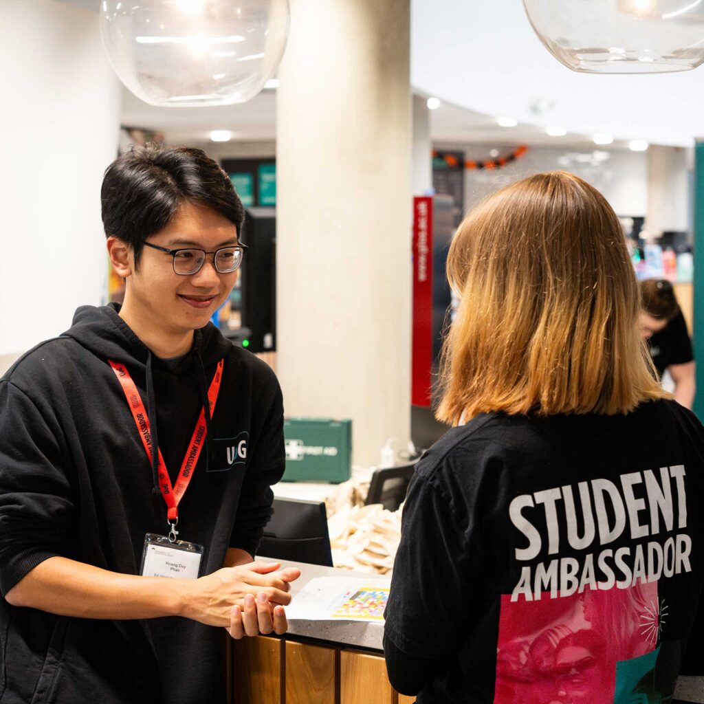 Two student ambassadors talk together at an open day.