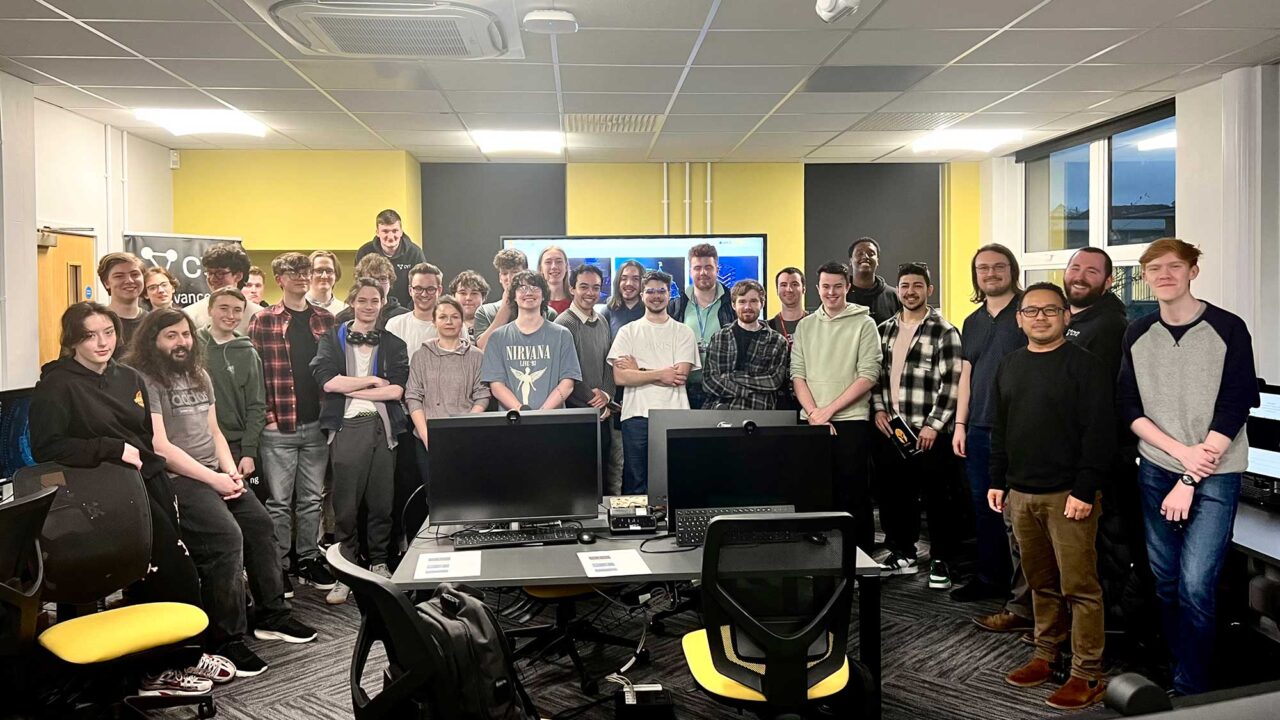 A group of people taking part in the Digital Capture the Flag cyber security event in a classroom at FuturePark