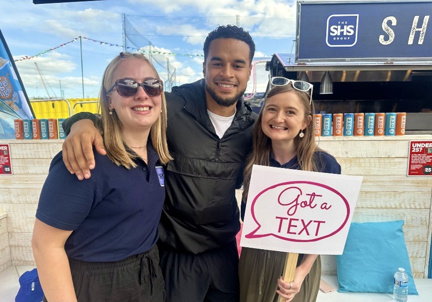 A student on placement with SHS poses for a photo with Live Island's influencer Toby and a UoG Business and Management alumni.