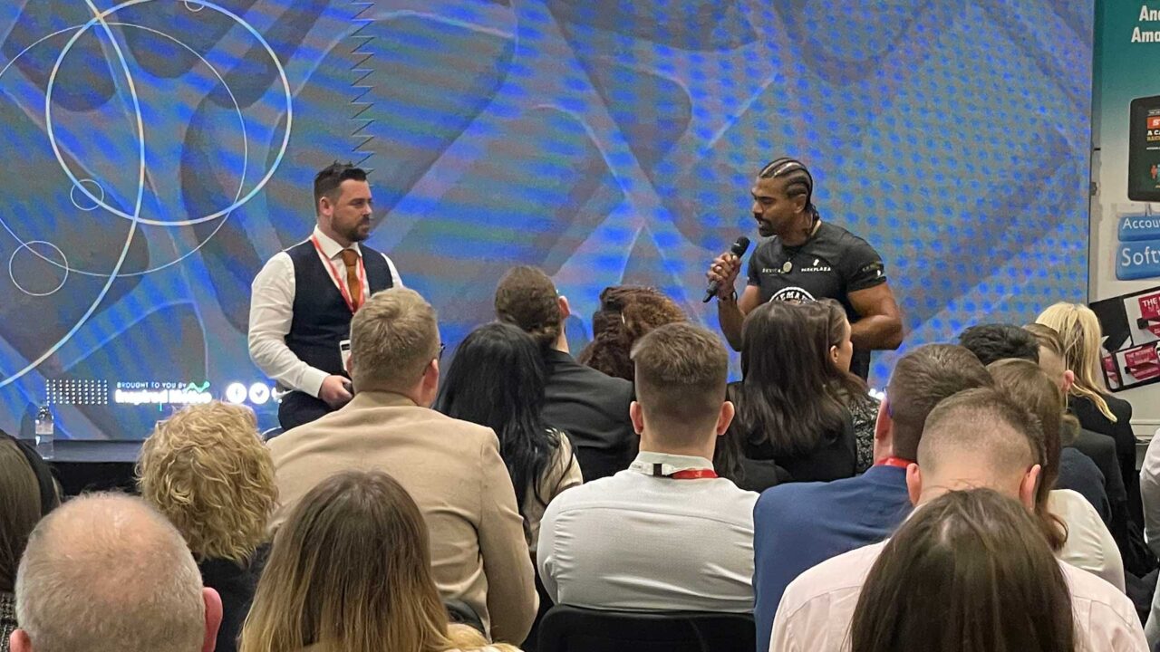 Speakers on the stage at an event at London Excel.
