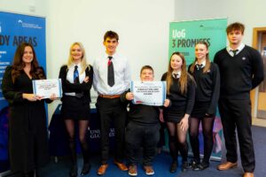 School students pose for a group photo holding their certificates of the Innovation and Entrepreneurship Award.
