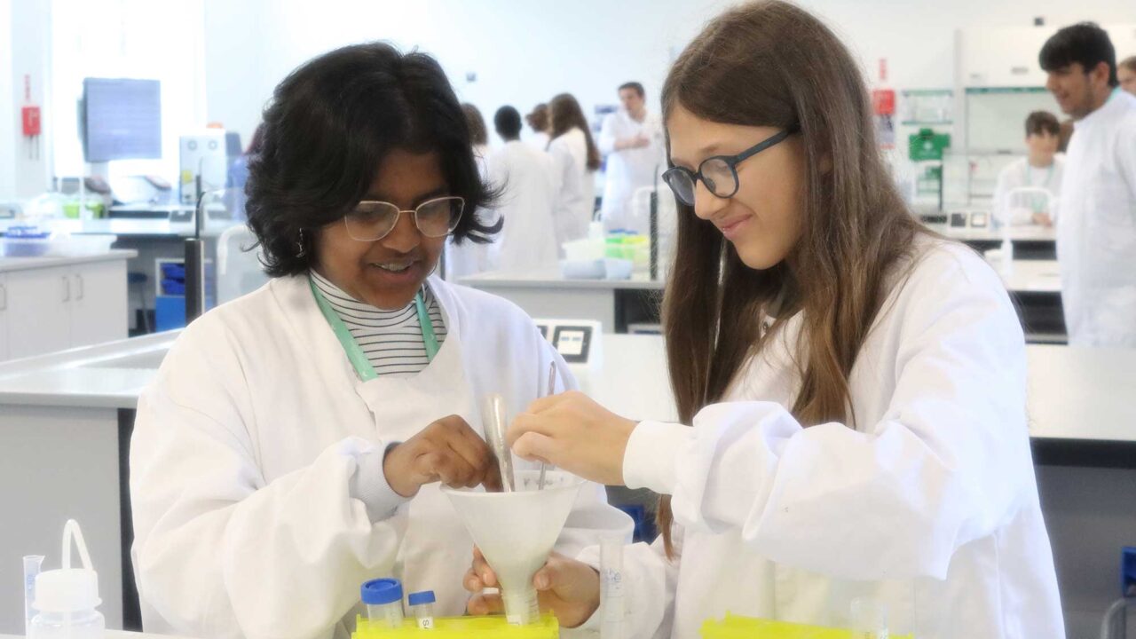 Two school students using equipment in the biosciences lab.