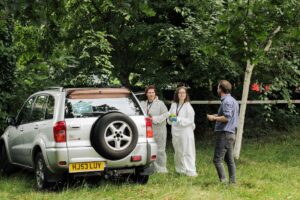 Year 12 students examine a mock crime scene during the summer residential.