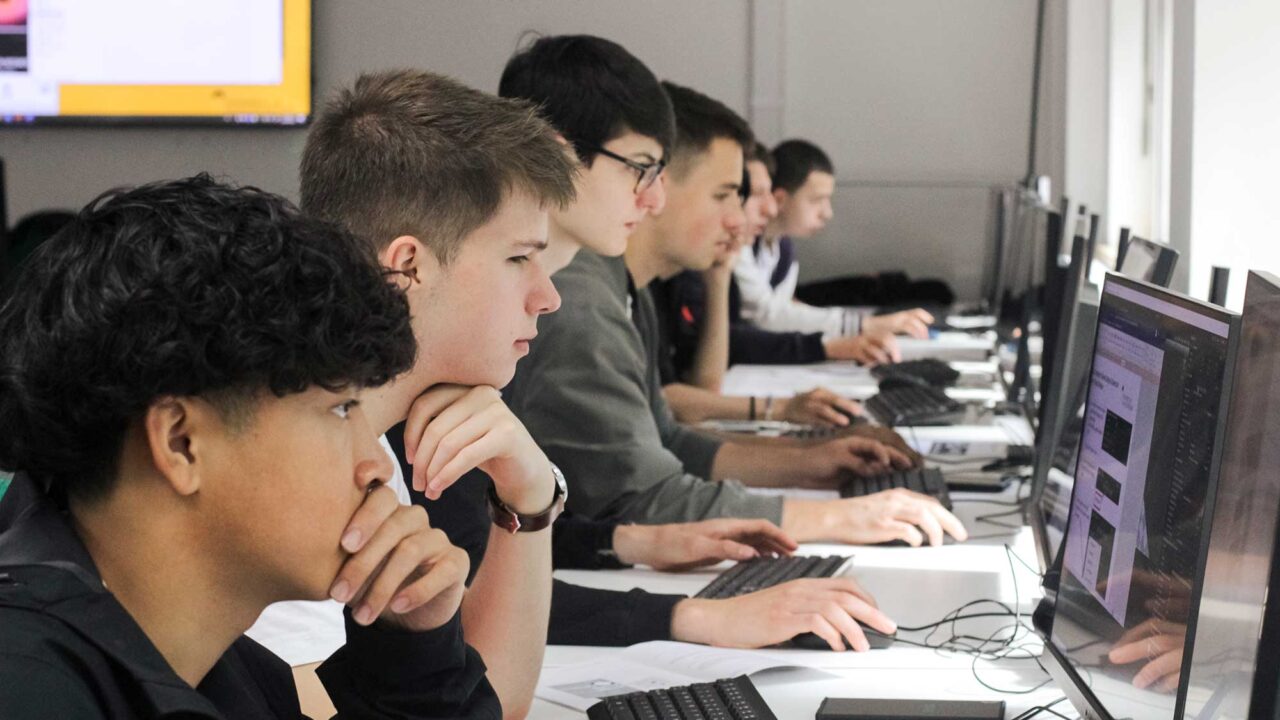 Year 12 students using computers during their summer residential.