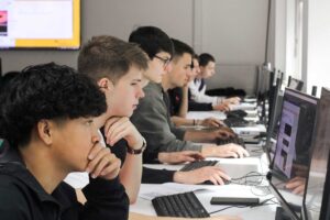 Year 12 students using computers during their summer residential.