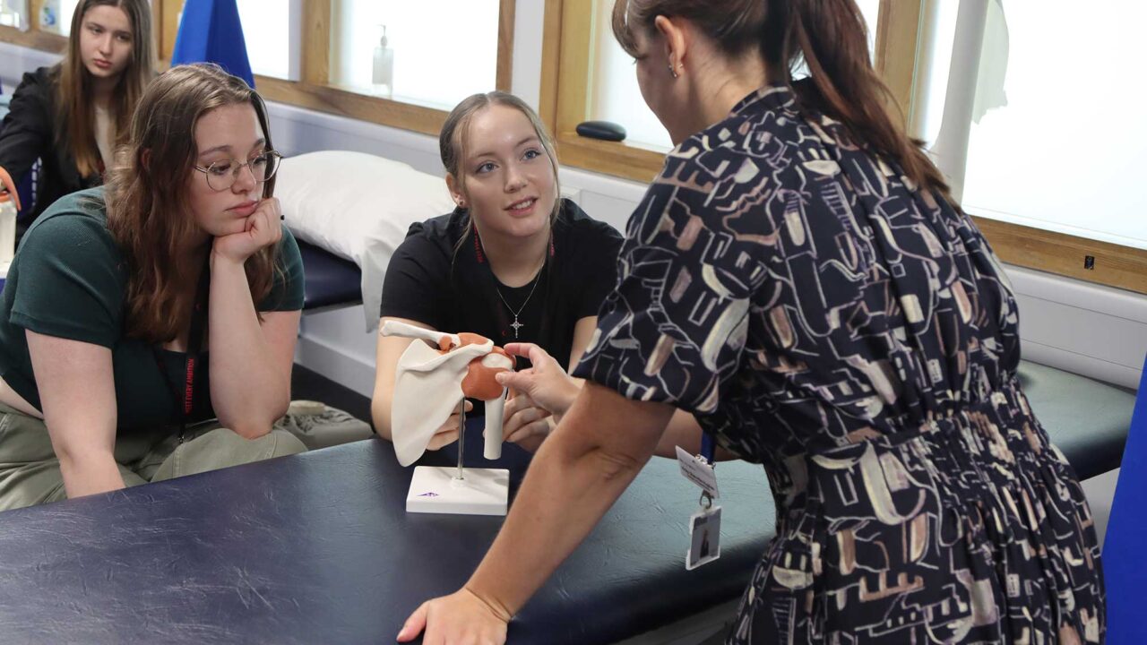 Students examine a model of a human joint on the Year 12 summer residential.