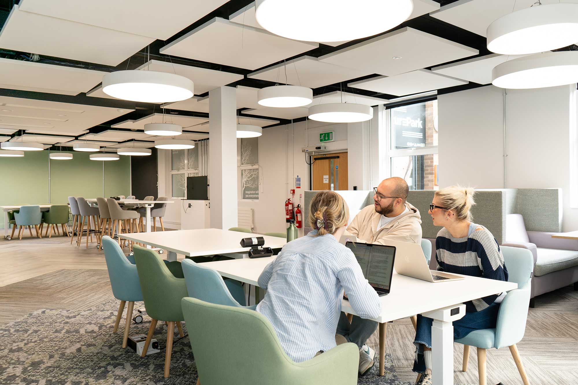 Students working on laptops in a break-out space in FuturePark.