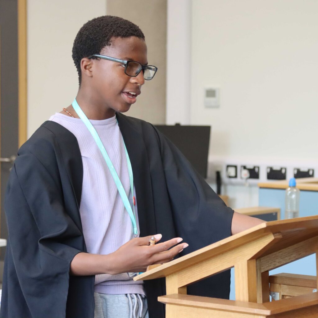 A year 10 student wearing legal robes during a law session on a summer residential.