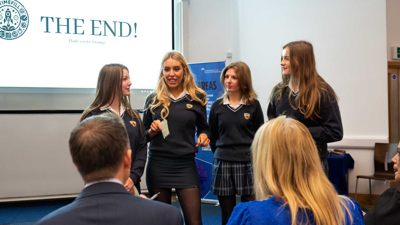 Four schoolgirls on the stage at the Business competition Final event.