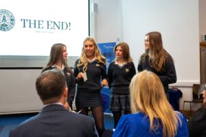 Four schoolgirls on the stage at the Business competition Final event.