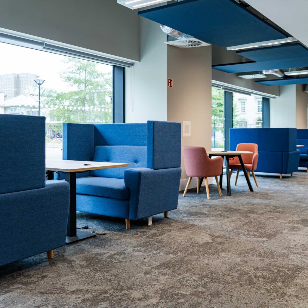A study space within City Campus showing seating booths and work areas.
