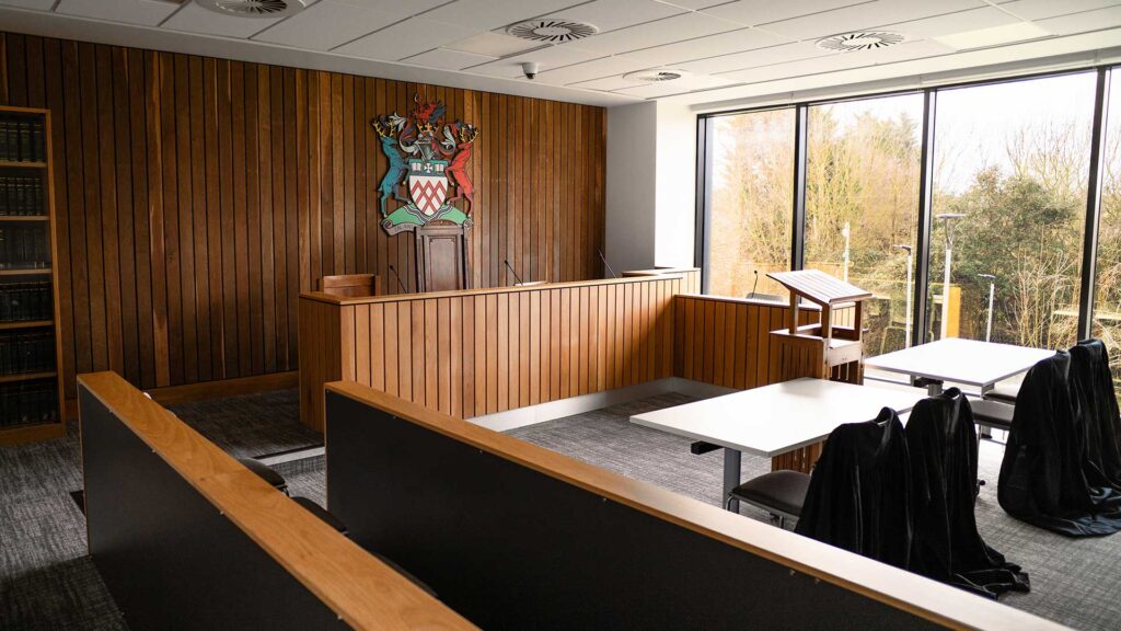 The Moot Court room set up with gowns on chairs at the Business School at Oxstalls campus.